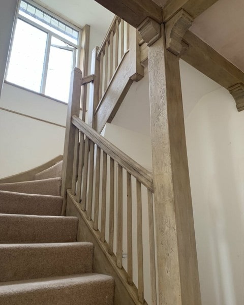 An image showing an oak beam staircase in a home